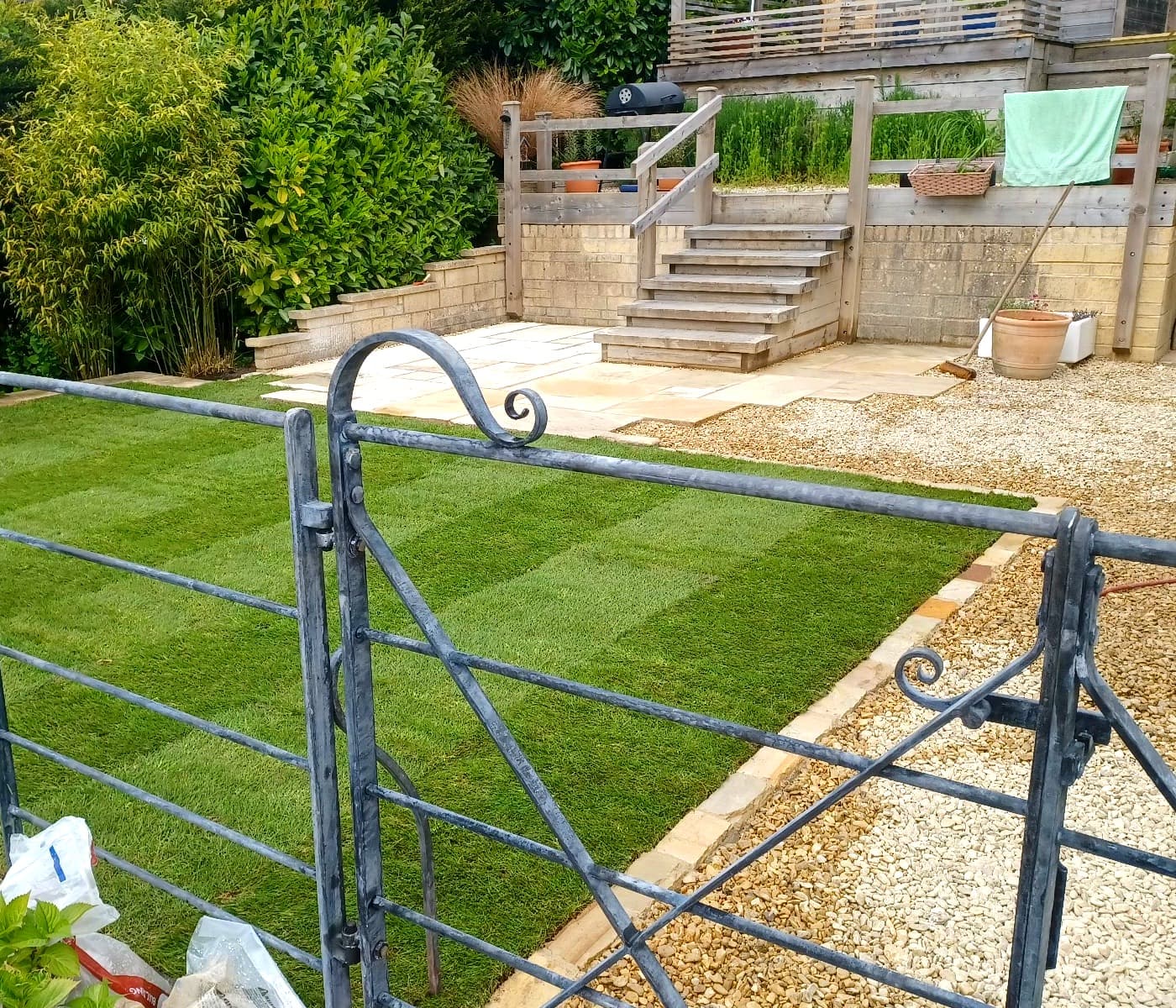 Tiered garden with new turf, gravel and wooden steps